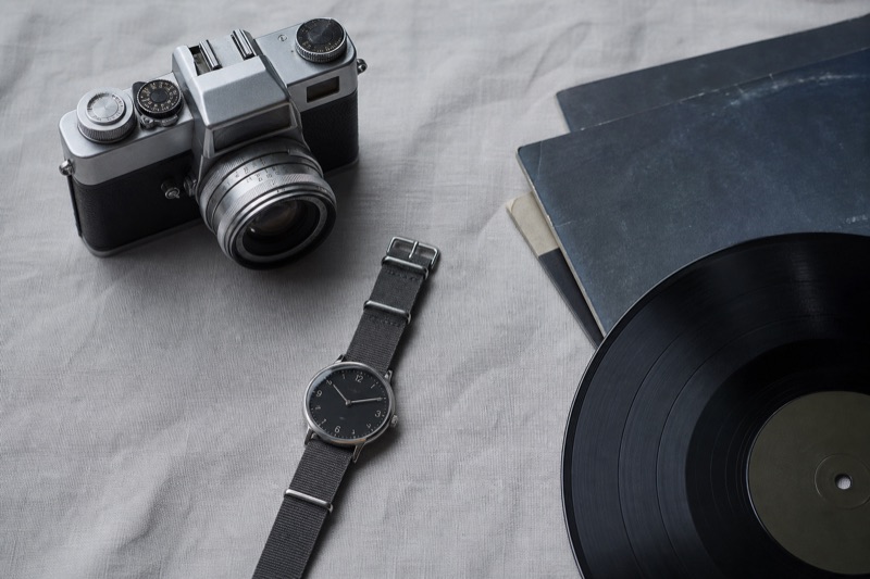 A vintage camera, watch, and vinyl records